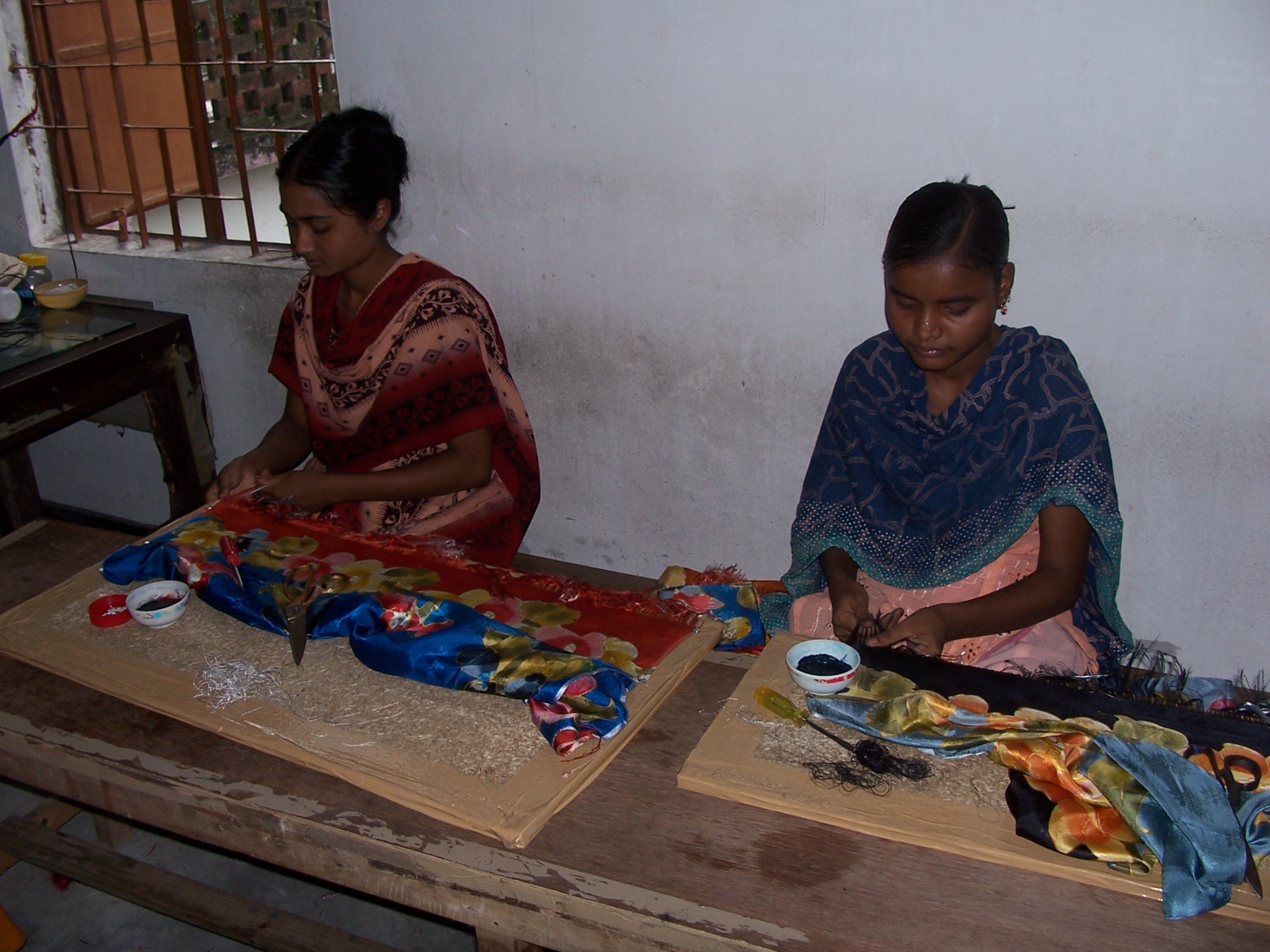 Two women working in a silk shop