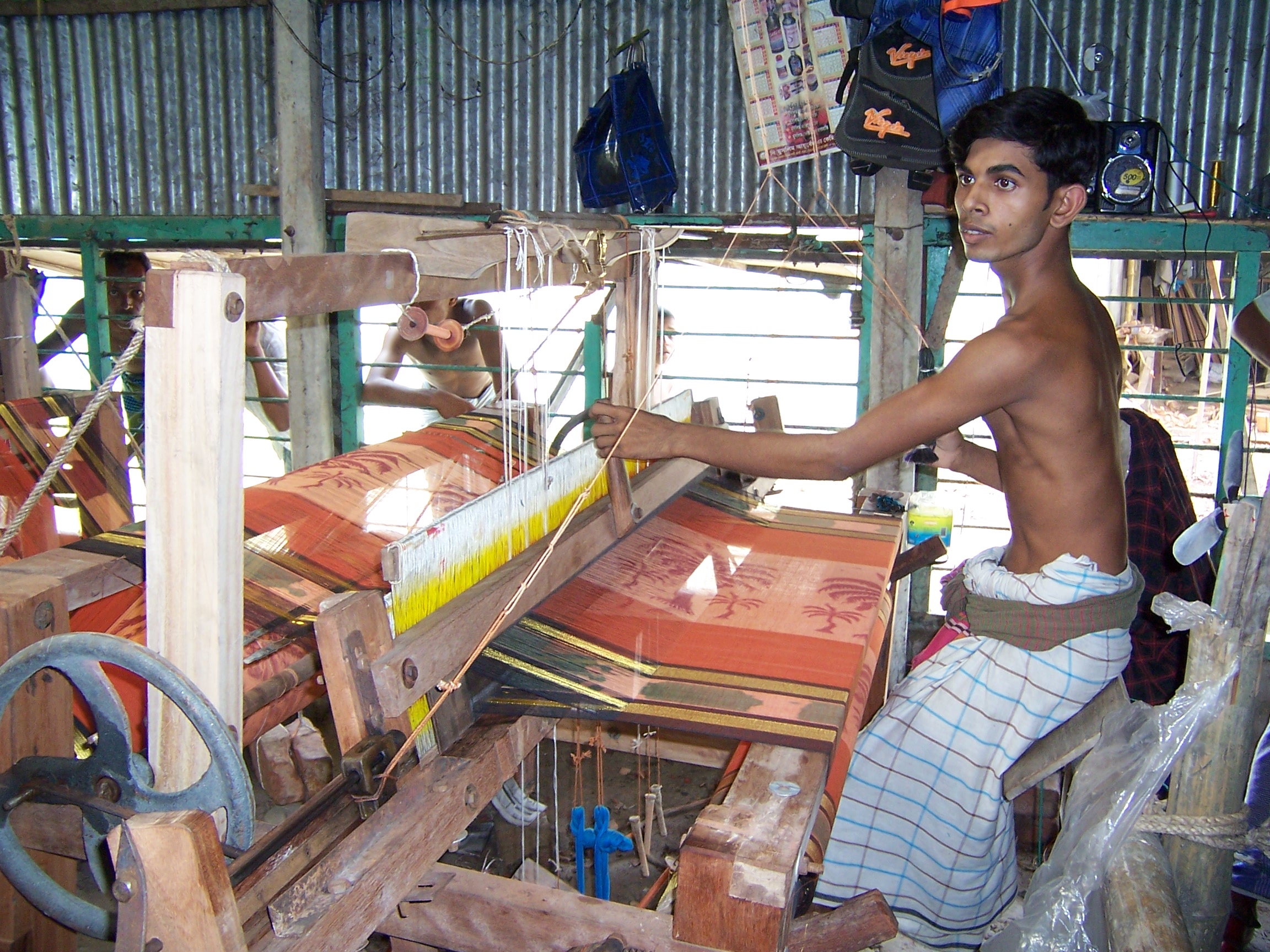 A boy working a silk loom 