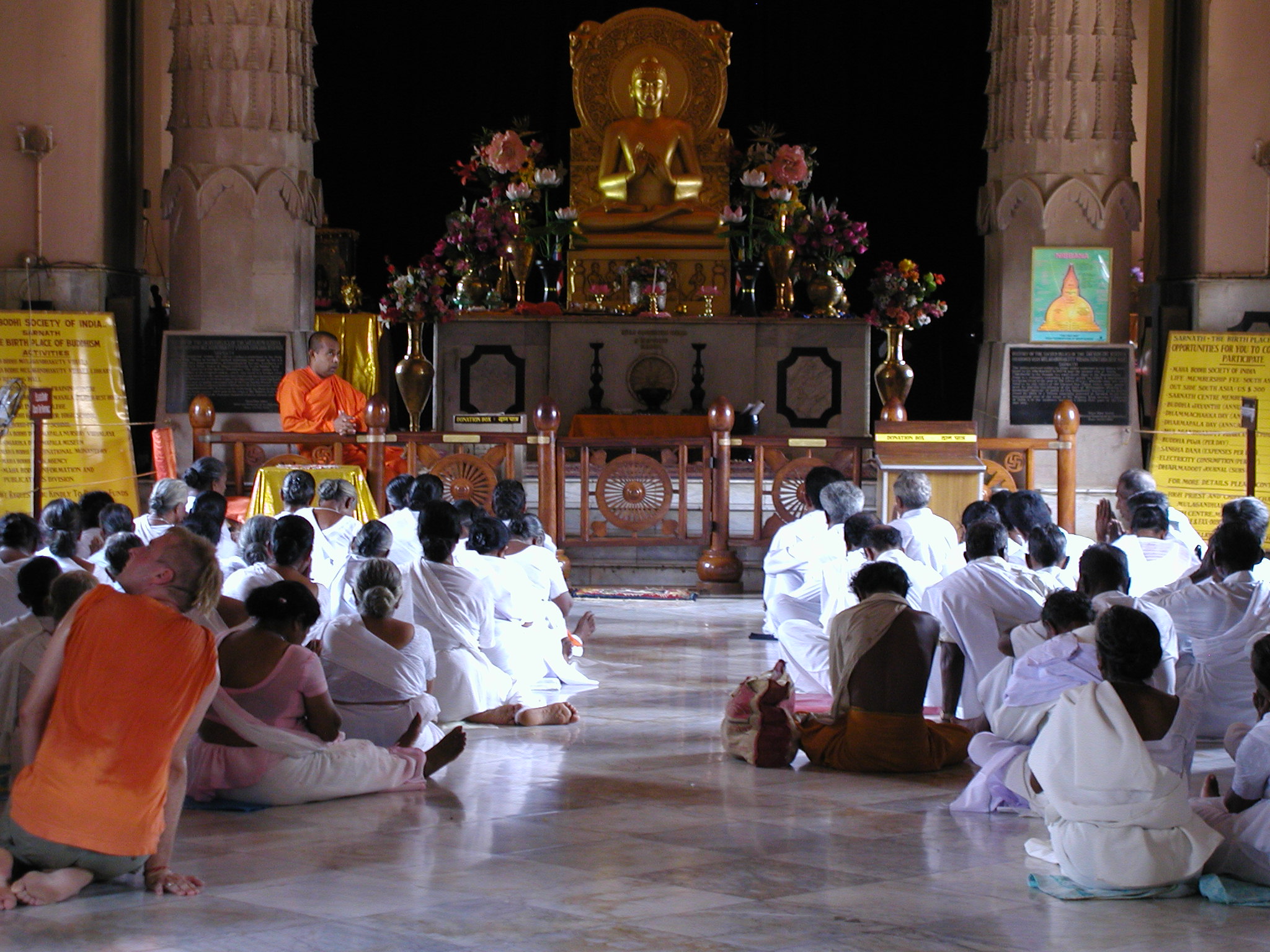 People worshiping in a Buddhist temple 