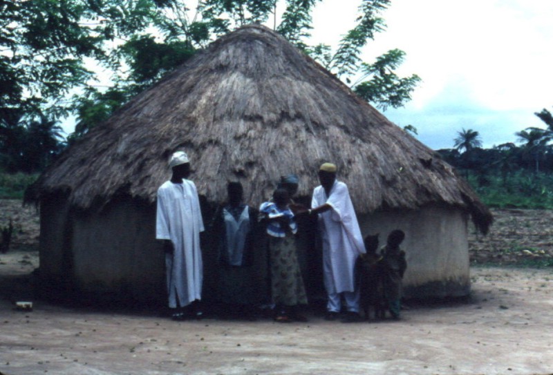 A family in front of their hut