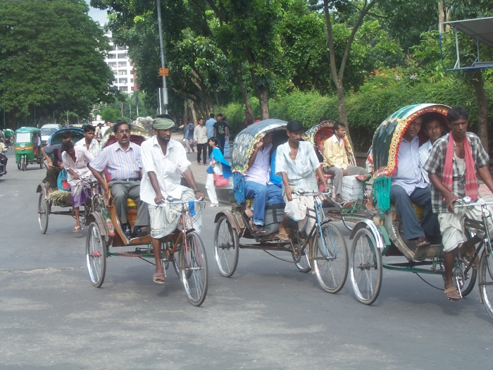 People on bikes pulling carts