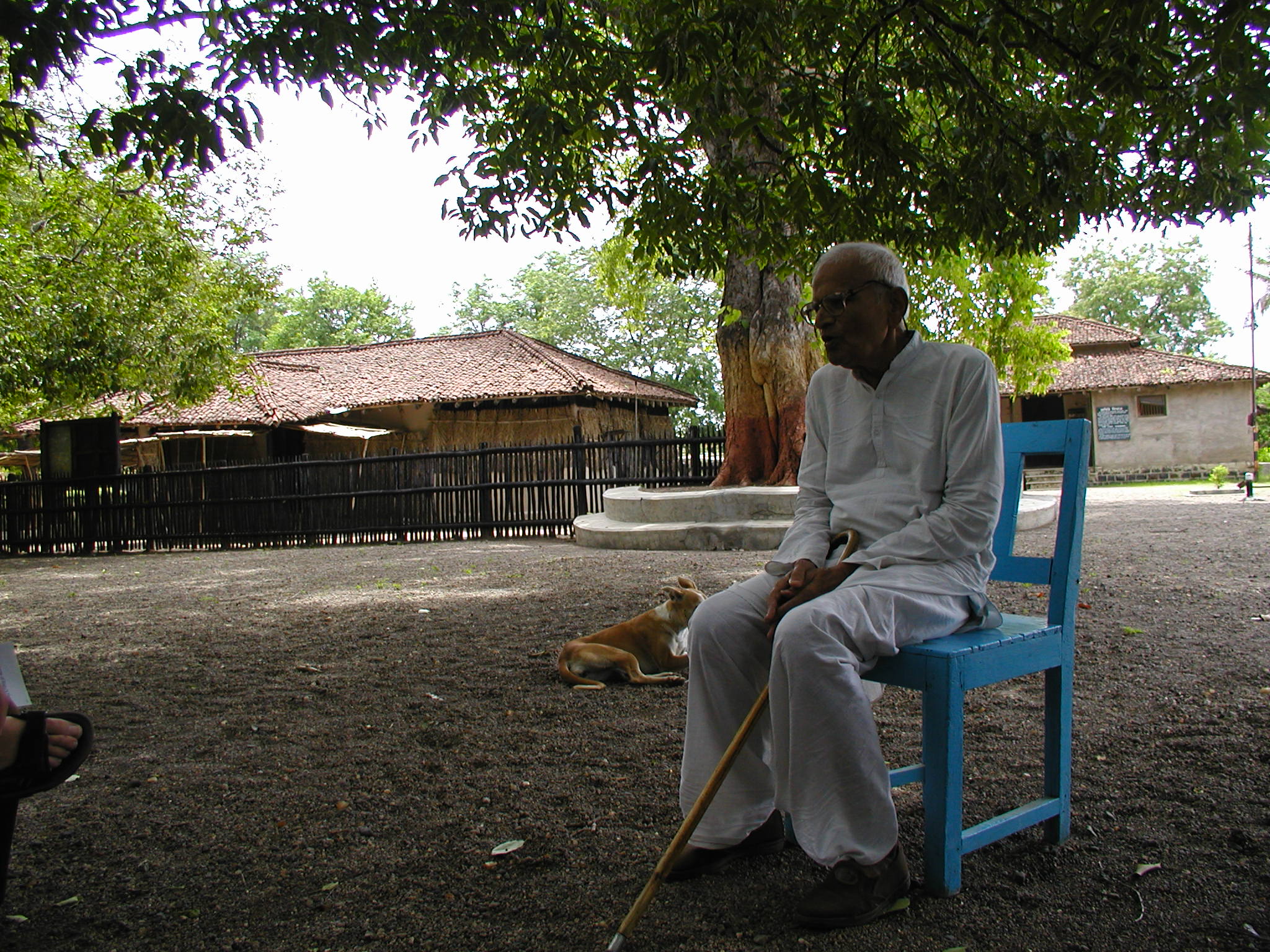 A man sitting and speaking at Ghandi Ashram 