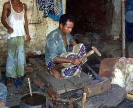 A blacksmith practices his craft.