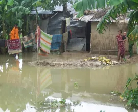 A family lives along the water in poverty-stricken conditions.