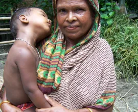 A mother and son in traditional dress.