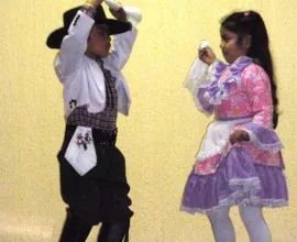 Children at the Escuela Lucila Godoy Alcayaga in Hualpén perform the Cueca, Chile's traditional national dance.