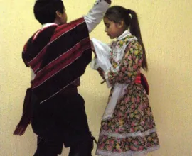 Children at the Escuela Lucila Godoy Alcayaga in Hualpén perform the Cueca, Chile’s traditional national dance.