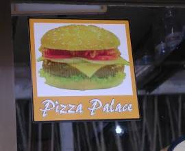 A Pizza Palace sign in Bangladesh advertises cheeseburgers.