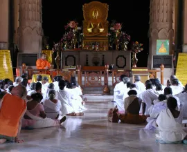 People worshiping in a Buddhist temple.