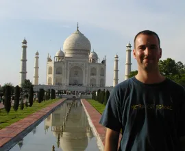 Iowa teacher, Dan, stand in front of the iconic Taj Mahal.
