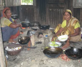 Two women prepare a meal.