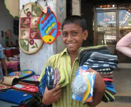 A boy displays his purchases after shopping.