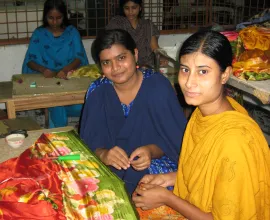 Women working with vibrant silk.