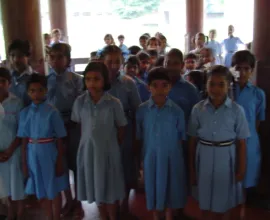 Children take a picture in their school uniforms.