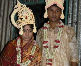 A newlywed couple in traditional wedding attire.