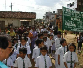 Children line up in their school uniforms.