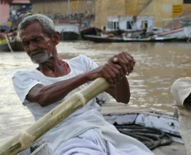 A man rows his boat in Varanasi.