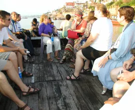 Iowa educators take a boat ride along the shore of Varanasi.